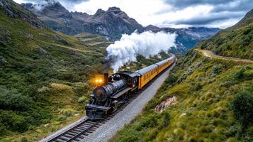 A steam train traveling through the mountains photo