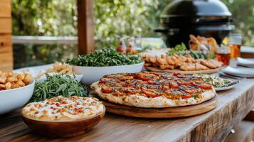 A table with a pizza, salad, and other food photo