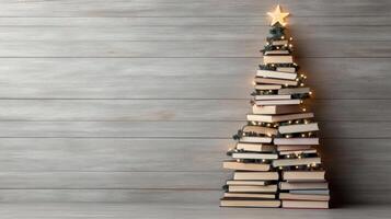 Christmas tree made of books on wooden background photo
