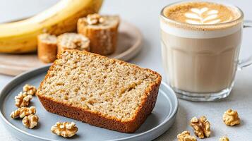 A loaf of banana bread on a plate next to a cup of coffee photo