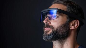 A man wearing a pair of glasses with blue light photo