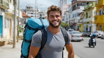 A man with a backpack smiles while walking down the street photo