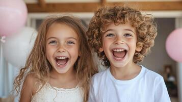 Two children are laughing and smiling in front of balloons photo