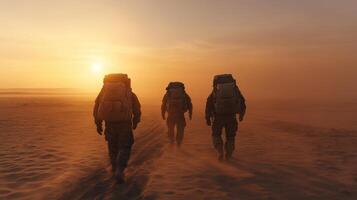 Three soldiers walking in the desert at sunset photo