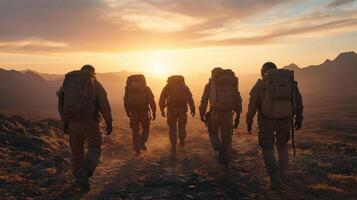 Group of soldiers walking in the desert at sunset photo
