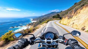 A motorcycle driving down a road with the ocean in the background photo