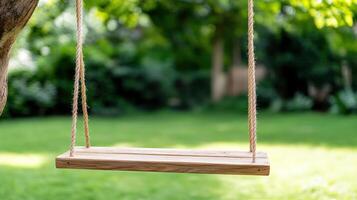 A wooden swing hanging from a tree in a garden photo