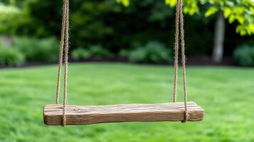 A wooden swing hanging from a tree in a yard photo