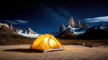A tent lit up in the desert at night photo
