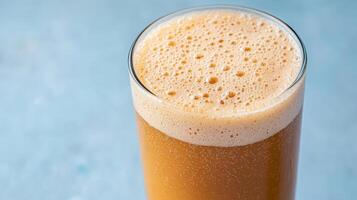 A glass of orange juice on a blue background photo