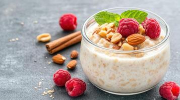 Healthy oats with nuts and raspberries on a dark background photo