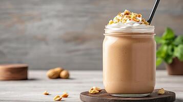 A milkshake with whipped cream and nuts on a wooden table photo