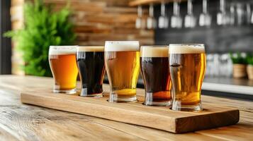 A row of beer glasses on a wooden tray photo
