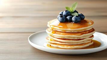 A stack of pancakes with blueberries on top photo