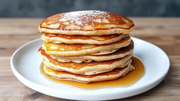 A stack of pancakes on a plate with syrup photo