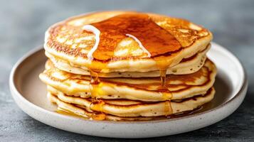 A stack of pancakes with syrup on top photo