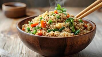 Quinoa, carrots, and broccoli in a bowl photo