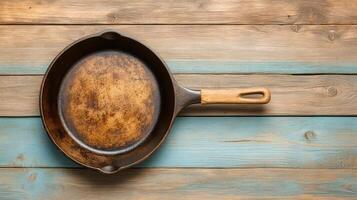 An old cast iron skillet on a wooden table photo