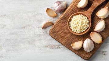Garlic and garlic cloves on a wooden cutting board photo