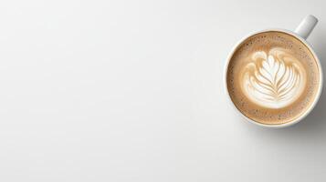 A cup of coffee with a latte art on top of a white table photo
