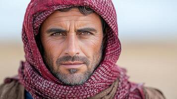 A man in a red scarf and a blue scarf photo