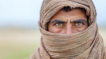 A man with a scarf covering his face photo