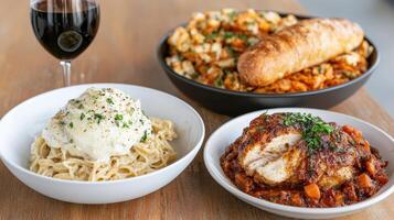 Three bowls of food with a glass of wine photo