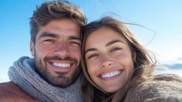 A man and woman are smiling while taking a selfie photo