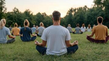 People meditating in a field at sunset photo