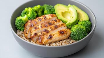 A bowl of rice, broccoli and chicken photo