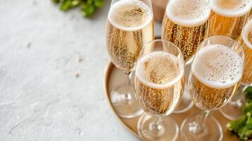 Champagne glasses on a tray with herbs photo