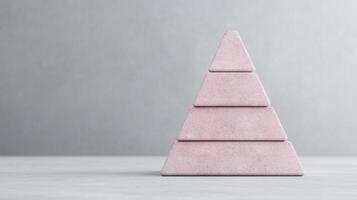 A pink pyramid shaped object on a table photo
