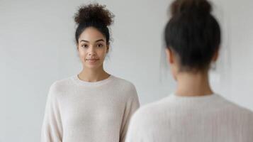 A woman looking at herself in the mirror photo