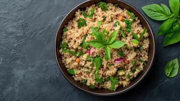 Crispy quinoa salad with fresh herbs on a dark background photo