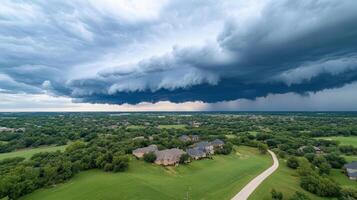 A large storm cloud is seen over a residential area photo