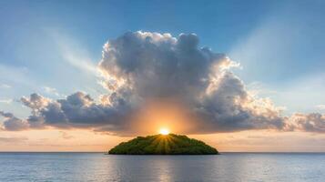 A small island with clouds in the sky at sunset photo