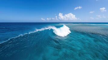 A large wave in the ocean with a blue sky photo