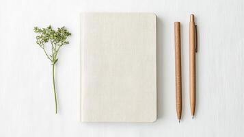 Blank notebook with pencils and flowers on white background photo