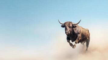 A bull is running in the air on a blue sky photo
