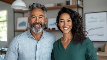 A man and woman standing in front of a desk photo