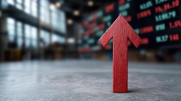A red arrow pointing upward in front of a stock market board photo