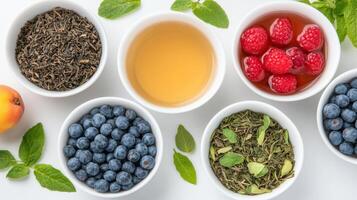 Various types of tea in bowls with berries and blueberries photo