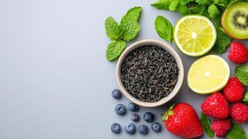 Fresh fruits and tea with mint, lemon, blueberries and mint photo