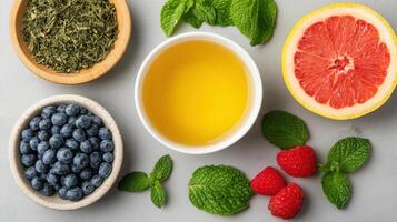 Various fruits and berries in bowls with tea photo