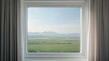 Window view of a green valley and mountains from a window photo