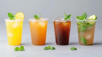 Four different types of iced drinks in glasses photo