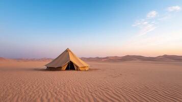 A tent in the desert at sunset photo