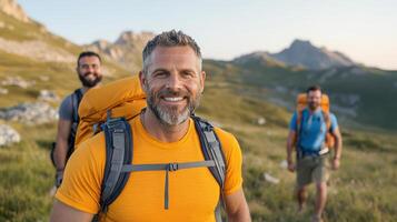 Three men with backpacks walking in the mountains photo