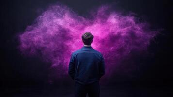 A man standing in front of a purple smoke cloud photo