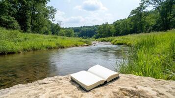 A book on a rock by a river photo